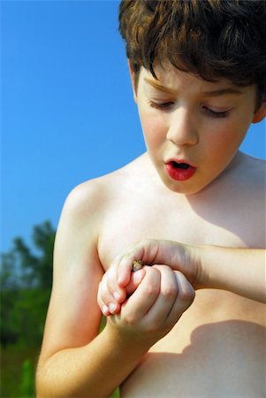 Young boy holding a tiny frog in his hands Stock Photo - Budget Royalty-Free & Subscription, Code: 400-04452098