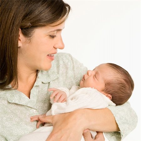 Mother holding baby smiling against white background. Stock Photo - Budget Royalty-Free & Subscription, Code: 400-04452246
