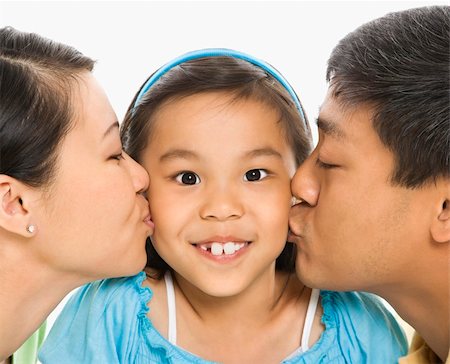 filipina mother daughter - Asian mother and father kissing opposite cheeks of smiling daughter in front of white background. Photographie de stock - Aubaine LD & Abonnement, Code: 400-04452253