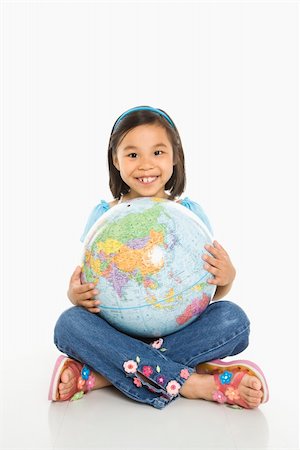 Asian girl sitting on floor holding Earth globe in her lap. Stock Photo - Budget Royalty-Free & Subscription, Code: 400-04452261