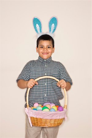 simsearch:400-04452450,k - Hispanic boy wearing bunny ears holding Easter basket smiling and looking at viewer. Stock Photo - Budget Royalty-Free & Subscription, Code: 400-04452439