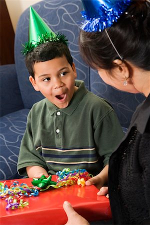 simsearch:400-04452450,k - Mother giving present to surprised son at birthday party. Stock Photo - Budget Royalty-Free & Subscription, Code: 400-04452447