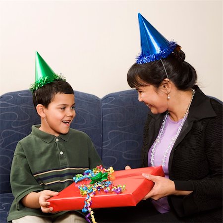 simsearch:400-04452450,k - Mother giving present to surprised son at birthday party. Stock Photo - Budget Royalty-Free & Subscription, Code: 400-04452448