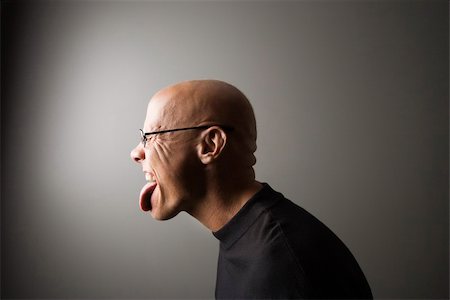 Profile portrait of mid-adult Caucasian male sticking out tongue. Stock Photo - Budget Royalty-Free & Subscription, Code: 400-04452752