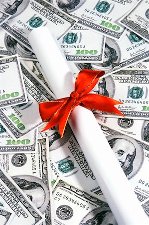 simsearch:400-09098178,k - A rolled up certificate lay over hundred dollar notes. Stock Photo - Budget Royalty-Free & Subscription, Code: 400-04452829