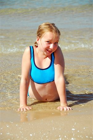 Young girl lying on a beach in shallow water Photographie de stock - Aubaine LD & Abonnement, Code: 400-04453085