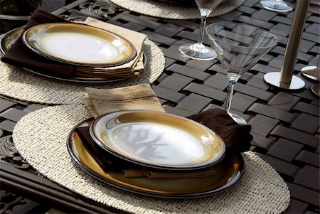 simsearch:400-04064749,k - Table setting on a patio table with plates and martini glasses Stock Photo - Budget Royalty-Free & Subscription, Code: 400-04453106