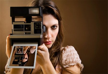 stylish woman snapshot - old-fashioned: girl taking a picture with an old polaroid Stock Photo - Budget Royalty-Free & Subscription, Code: 400-04453751