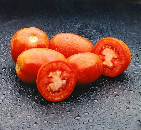 simsearch:400-05292254,k - Five red tomatoes with drops over a black surface. Look at my gallery for more fresh fruits and vegetables. Photographie de stock - Aubaine LD & Abonnement, Code: 400-04464440