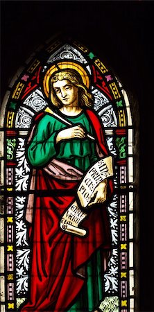 detail of viktorian stained glass church window in Fringford depicting St John the Evangelist, a scroll in his hands with the beginning of his gospel in latin "In principio erat verbum" Stock Photo - Budget Royalty-Free & Subscription, Code: 400-04464584