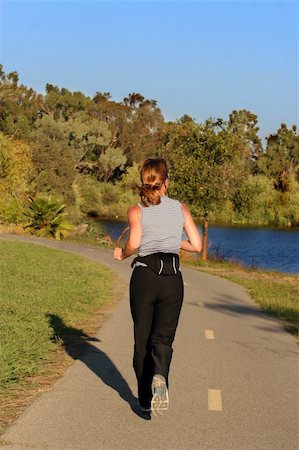 simsearch:400-05025032,k - Woman jogging along a river at sunset Stock Photo - Budget Royalty-Free & Subscription, Code: 400-04464757