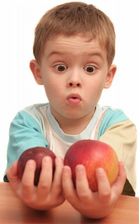 The child holds two different fruit in hands Stock Photo - Budget Royalty-Free & Subscription, Code: 400-04465014