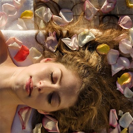 someone laying down aerial view - Above view of bare Caucasian mid-adult  woman lying down with eyes closed and hair spread out surrounded by rose petals. Stock Photo - Budget Royalty-Free & Subscription, Code: 400-04465219