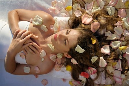 someone laying down aerial view - Above view of Caucasian mid-adult woman wrapped in sheet lying down with hair spread out on rose petals. Stock Photo - Budget Royalty-Free & Subscription, Code: 400-04465221