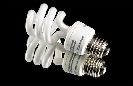 simsearch:400-04750349,k - An energy effecient fluorescent light bulb isolated on a black background, shot over a mirror Stock Photo - Budget Royalty-Free & Subscription, Code: 400-04465429