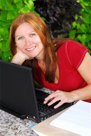 Happy mature woman working on portable computer at home, small business owner Photographie de stock - Aubaine LD & Abonnement, Code: 400-04466006