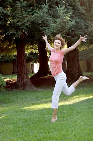 simsearch:400-04461812,k - happy woman running barefooted on grass. Stock Photo - Budget Royalty-Free & Subscription, Code: 400-04466477