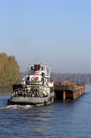rimorchiatore - Barge pushed by towboat on the river. Copyspace is provided. Fotografie stock - Microstock e Abbonamento, Codice: 400-04466479