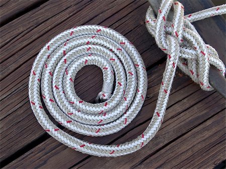 rope deck knot - white boater's rope artistically coiled and attached to cleat on dock Stock Photo - Budget Royalty-Free & Subscription, Code: 400-04466498