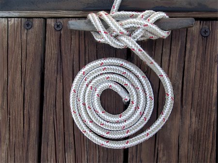 rope deck knot - white boater's rope artistically coiled and attached to cleat on dock Stock Photo - Budget Royalty-Free & Subscription, Code: 400-04466502