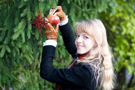 Young girl is putting toys on a Christmas Tree Stock Photo - Budget Royalty-Free & Subscription, Code: 400-04466747