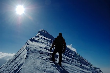 A lonely climber reaching the summit of the mountain Stock Photo - Budget Royalty-Free & Subscription, Code: 400-04466852
