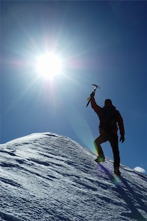 A lonely climber reaching the summit of the mountain Stock Photo - Budget Royalty-Free & Subscription, Code: 400-04466853