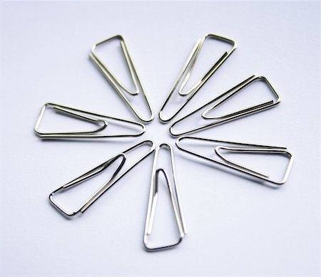 Metal Paper Clips On White Background form up a pattern. Stock Photo - Budget Royalty-Free & Subscription, Code: 400-04467008