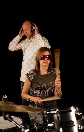 simsearch:400-06133570,k - drummer playing over black backdrop with man standing in background Stock Photo - Budget Royalty-Free & Subscription, Code: 400-04467671