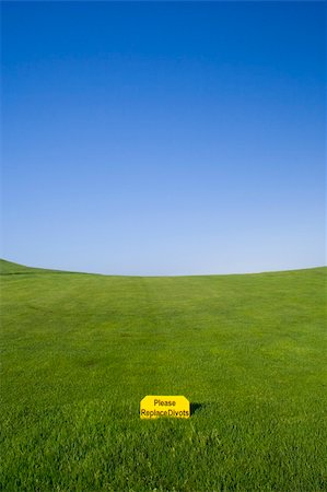 simsearch:400-03975619,k - a sign in a golf course saying "Please Relace divots" Stock Photo - Budget Royalty-Free & Subscription, Code: 400-04468036