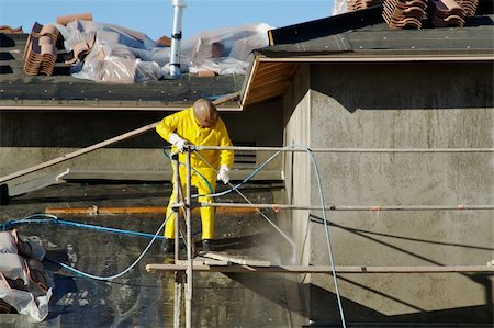 rain on roof - Construction worker pressure washes fresh applied surface of new home exterior. Stock Photo - Budget Royalty-Free & Subscription, Code: 400-04468369