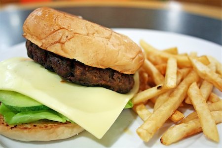 plate of hamburger and fries - Hamburger with cheese and fries, served on a plate Stock Photo - Budget Royalty-Free & Subscription, Code: 400-04468452