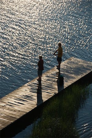 simsearch:400-03940596,k - Birds eye view of two teenage boys fishing from dock at Bald Head Island, North Carolina. Foto de stock - Super Valor sin royalties y Suscripción, Código: 400-04468769
