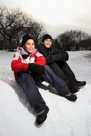 pictures of african american people in the snow - Two boys sitting in snow wearing coats and hats and smiling. Stock Photo - Budget Royalty-Free & Subscription, Code: 400-04468873