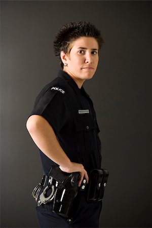 female guns in holsters - Portrait of mid adult Caucasian policewoman standing with hand on gun holster looking at viewer. Stock Photo - Budget Royalty-Free & Subscription, Code: 400-04468904