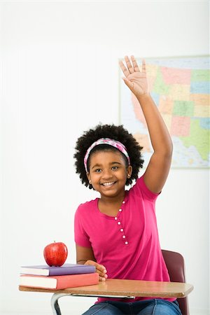simsearch:400-03923096,k - African American girl sitting in school desk raising hand and smiling at viewer. Stock Photo - Budget Royalty-Free & Subscription, Code: 400-04469049
