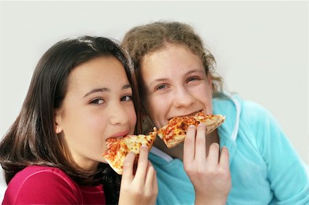 Two girls eating pizza Stock Photo - Budget Royalty-Free & Subscription, Code: 400-04469231