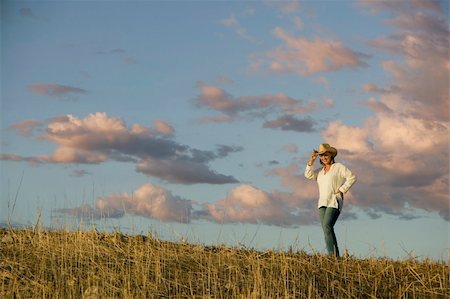 ranchers - Wide angle shot of a western woman against a cloudy sky at dusk. Stock Photo - Budget Royalty-Free & Subscription, Code: 400-04469518