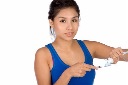 simsearch:400-04007612,k - Hispanic girl putting toothpaste on her toothbrush Stock Photo - Budget Royalty-Free & Subscription, Code: 400-04460281