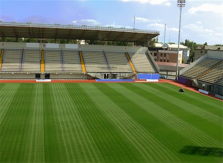 empty stage event - An empty soccer staduim with empty tribunes and grass brushed under blue sky Stock Photo - Budget Royalty-Free & Subscription, Code: 400-04460340