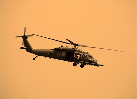 simsearch:400-04461335,k - Sepia toned military helicopter in flight Photographie de stock - Aubaine LD & Abonnement, Code: 400-04460610