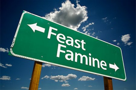 simsearch:400-04628504,k - "Feast or Famine" Road Sign with dramatic clouds and sky. Foto de stock - Royalty-Free Super Valor e Assinatura, Número: 400-04460637