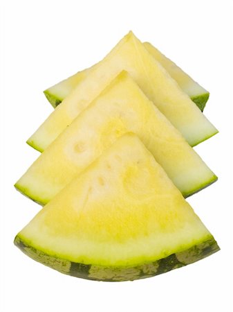 simsearch:400-04294971,k - Slices of a yellow watermelon on a white background. Shallow DOF, focus on the corner of the first slice. Photographie de stock - Aubaine LD & Abonnement, Code: 400-04460719