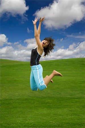 simsearch:400-06077546,k - Beautiful happy woman jumping on a green field Stockbilder - Microstock & Abonnement, Bildnummer: 400-04461055