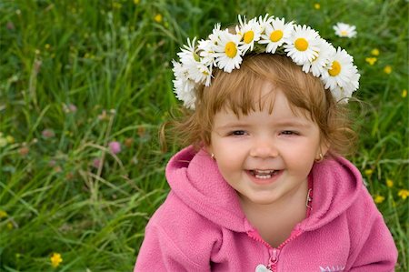 simsearch:400-06087517,k - Baby girl with daisy wreath looking up and laughing on the spring meadow full of flowers Stock Photo - Budget Royalty-Free & Subscription, Code: 400-04461109