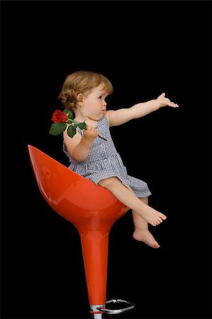 diverse families - Baby girl with a rose sitting on a red swivel chair - vintage effect with selective desaturation - isolated on black Foto de stock - Super Valor sin royalties y Suscripción, Código: 400-04461120