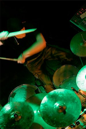 simsearch:400-06133570,k - drummer in shadow playing on drums illuminated with green light, drummer is in motion, drumsticks blurred Stock Photo - Budget Royalty-Free & Subscription, Code: 400-04462068