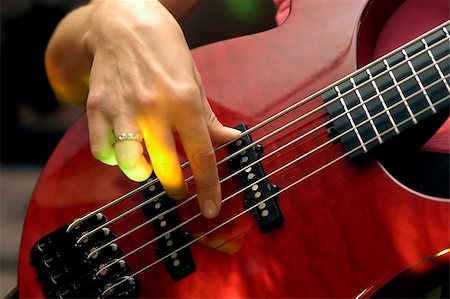 closeup of an female guitarist at a rock concert, motioneffect with a spotlight Stock Photo - Budget Royalty-Free & Subscription, Code: 400-04462214