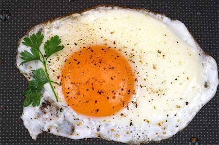 eggs with face - Fried egg on frying pan background Stock Photo - Budget Royalty-Free & Subscription, Code: 400-04462548