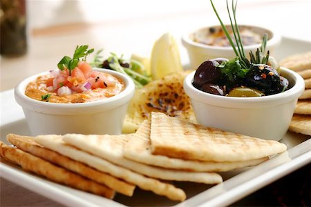 Sumptious platter of flat breads served with red pepper hummus dip, crab dip, olives and grilled haloumi cheese. Shallow DOF. Stock Photo - Budget Royalty-Free & Subscription, Code: 400-04463044